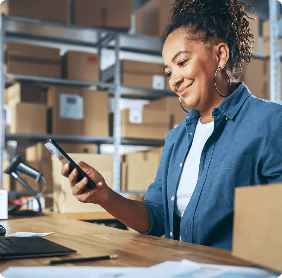 Warehouse worker checking phone alerts