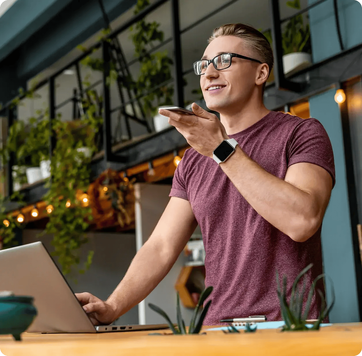 man-holding-cellphone-on-laptop