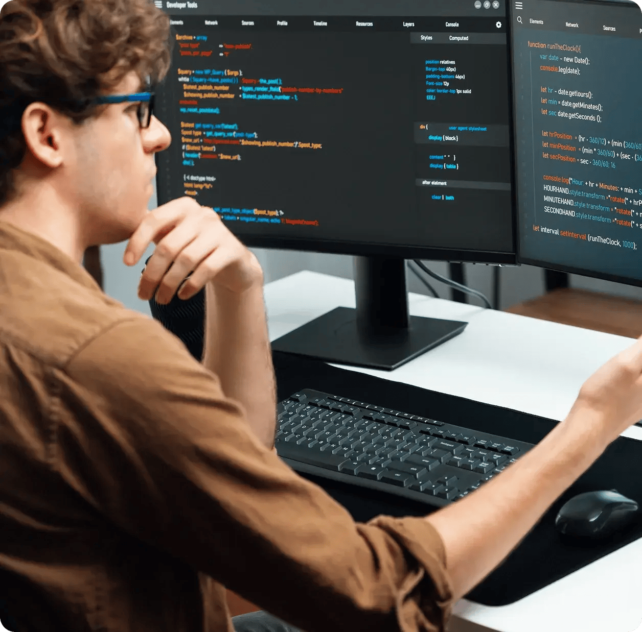 man-sitting-at-computer-code
