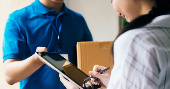 woman signing for package