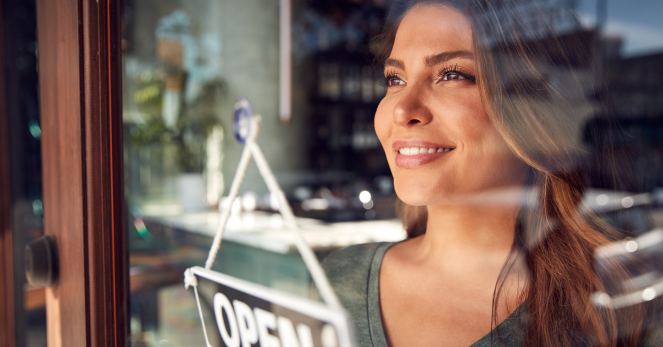 franchise owner looks out her window smiling